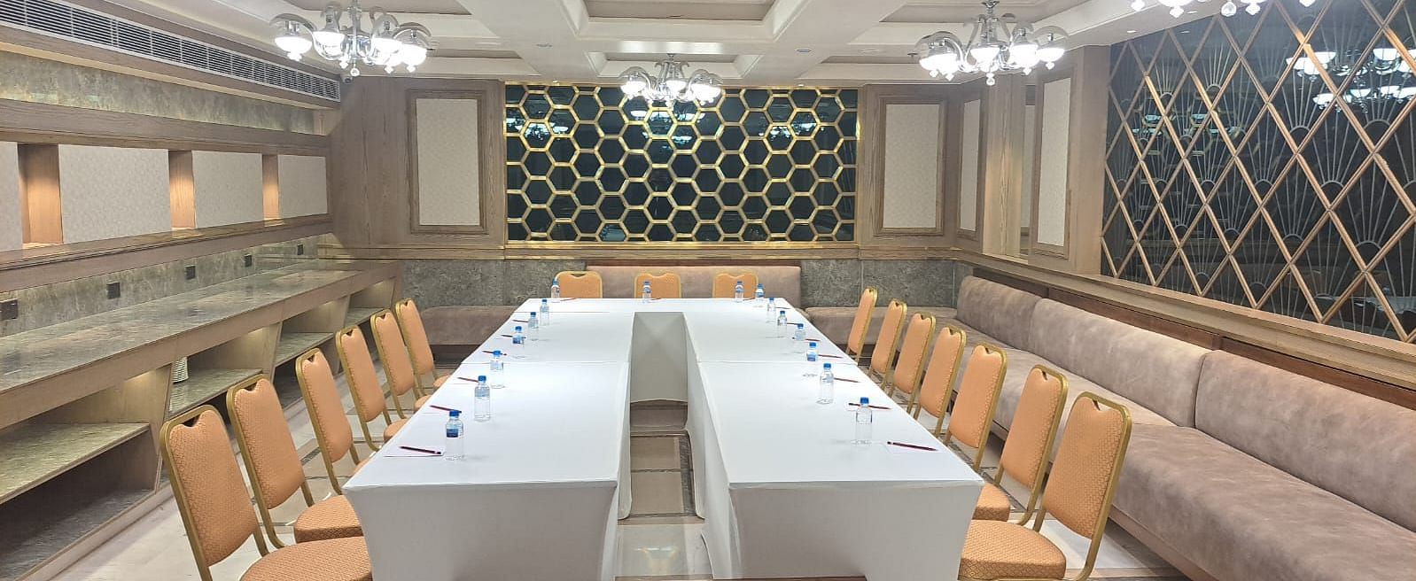 An event space with chairs arranged on both sides and tables placed in the middle at BluSalzz Residence, Amritsar